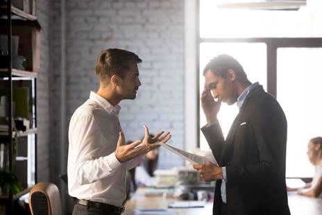 Men arguing at work - FMLA Retaliation